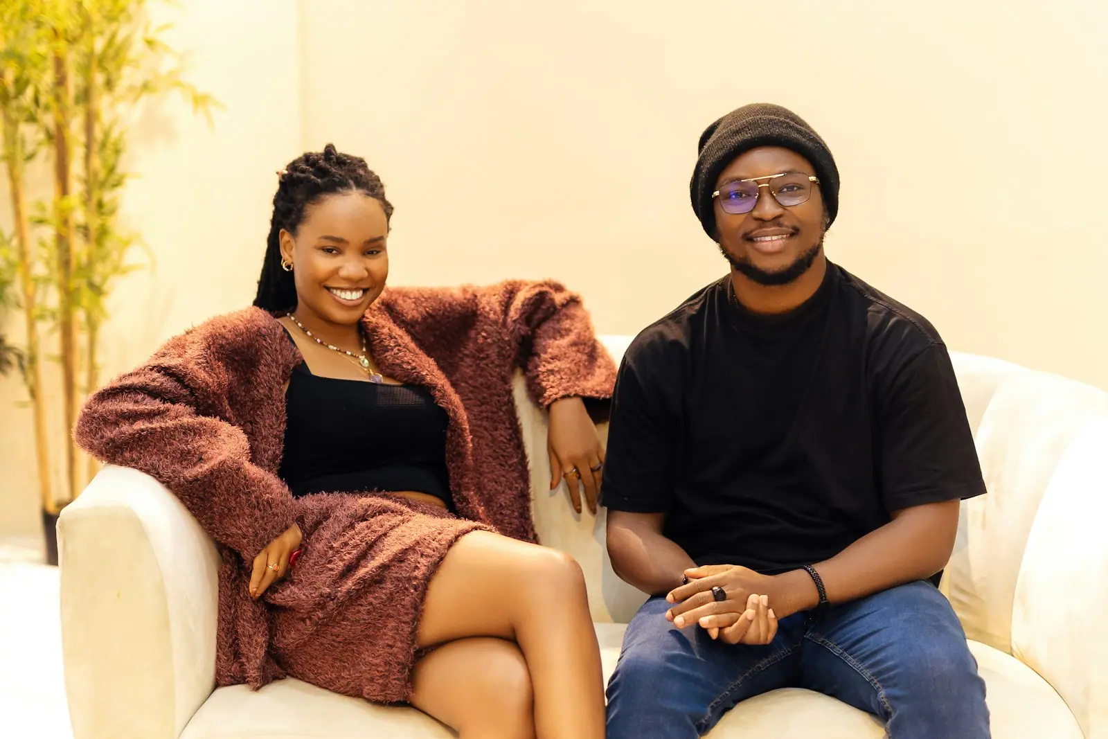 A young couple relaxing together on a cream sofa