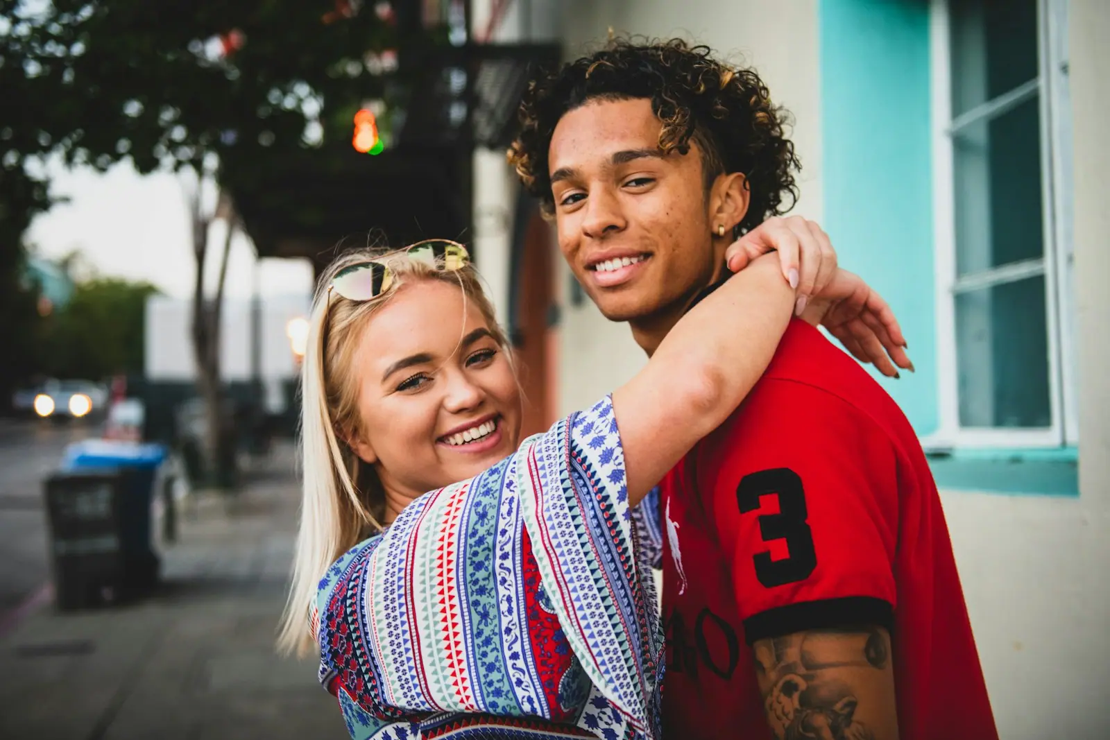 A young couple hugging and laughing in the street